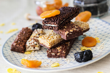 Granola energy bar with mix of nuts and fruits on a plate