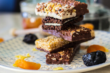 Granola energy bar with mix of nuts and fruits on a plate