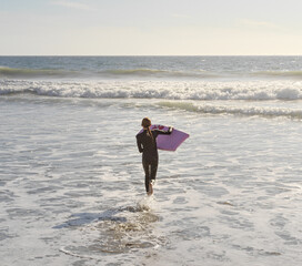 girl running into surf