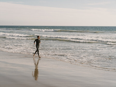 boy running in surf