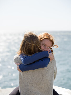 girl hugging mother
