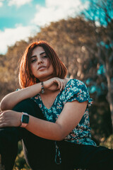 Fototapeta premium portrait of a woman sitting in the forest