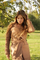 Beautiful girl in a coat in the park autumn landscape