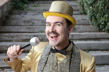Showman with golden outfit holding microphone