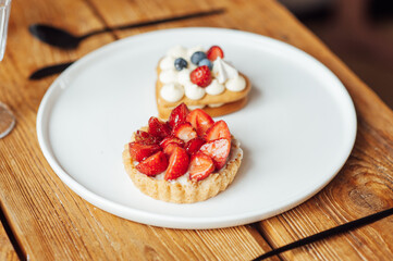 Fresh healthy breakfast in bed with cookies and strawberries