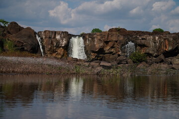 Fototapeta na wymiar Reflection of a waterfall in its water