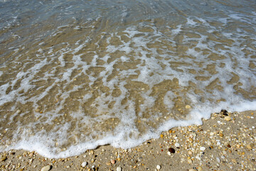 Fototapeta na wymiar Small waves washing up on the cape May beaches