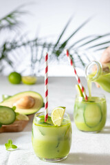 two glasses of vegan detox green smoothie on a white table