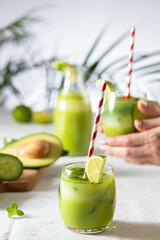 two glasses of vegan detox green smoothie on a white table
