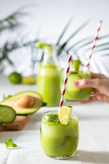 two glasses of vegan detox green smoothie on a white table