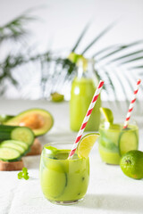 two glasses of vegan detox green smoothie on a white table