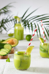 two glasses of vegan detox green smoothie on a white table