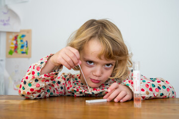 Cute blonde girl self testing for corona virus and waiting for results.