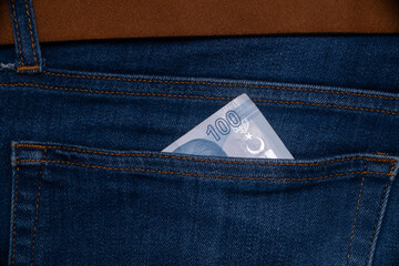 Money in blue jeans pocket
