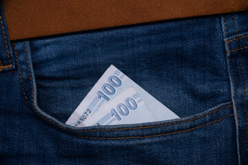 Money in blue jeans pocket