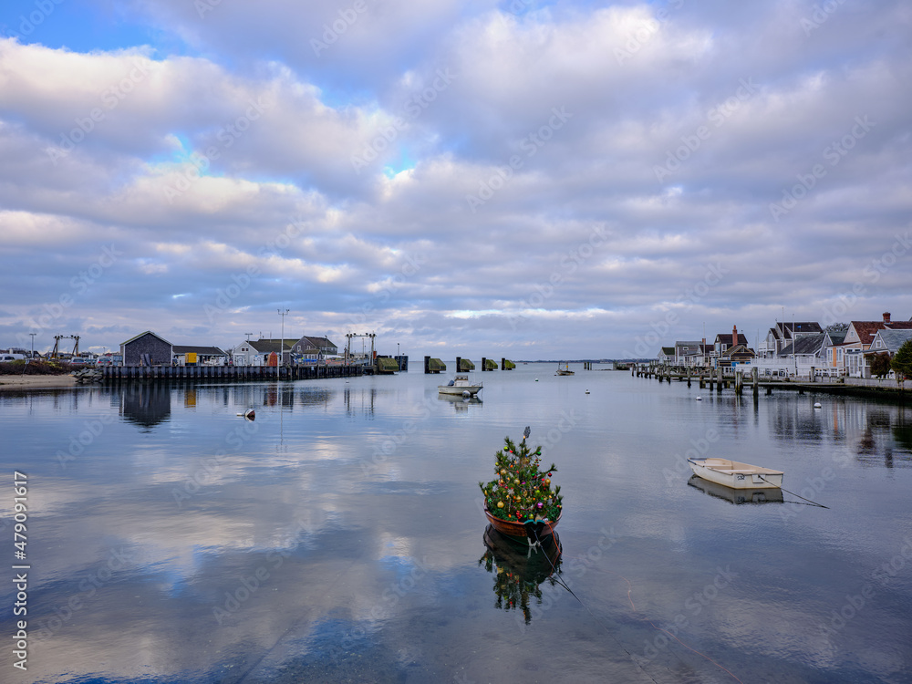 Wall mural Calm and peaceful waters of Nantucket with a christmas holiday tree on a skiff and the sky reflected on the waters