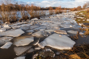 Close up view of ice drift on the frozen river. Melting ice. Flooded road. Concept of spring floods