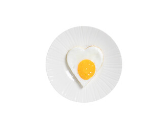 Fried eggs in the shape of a heart on a beige plate, isolated on a white background. Breakfast on Valentine's Day.