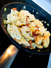 Homemade noodles on frying pan with bacon