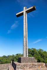 Fototapeta na wymiar The Cruz Alta viewpoint is the higest point in the Bussaco range in Portugal. The cross monument is under a blue sky