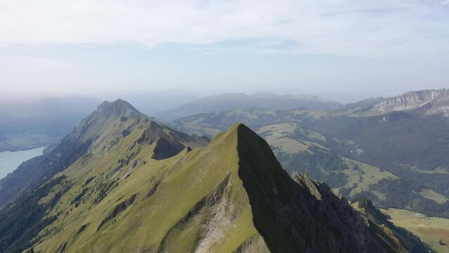 Amazing footage over the beautiful places in Switzerland. A wonderful areal flight at a sunny day in the alps. Epic drone flight over the beautiful mountains at the lake Brienz called Brienzergrat.