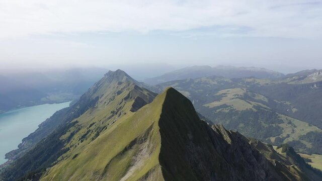 Amazing footage over the beautiful places in Switzerland. A wonderful areal flight at a sunny day in the alps. Epic drone flight over the beautiful mountains at the lake Brienz called Brienzergrat.