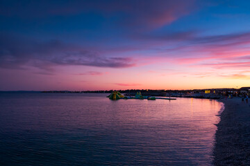 Fototapeta na wymiar Sea and beach on beautiful blue and purple sunset