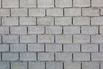 A rough gray wall of concrete blocks.