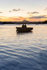 Silhouette of Couple Sitting in a Boat Looking the Sunset in Noosa River,Queensland,Australia