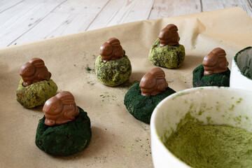 Chocolate easter bunnies on healthy vegan energy date balls covered in spirulina and matcha powder