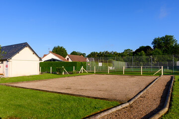 The petanque court in the traditional French village of Saint Sylvain in Europe, France, Normandy, towards Veules les Roses, in summer on a sunny day.