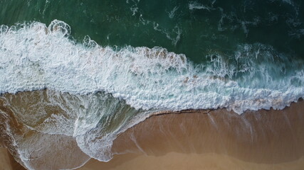 Fototapeta na wymiar Crashing Waves on Hawaii Beach Bird's eye view drone