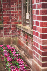 red brick wall with flowers