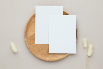 Blank paper cards, Greeting card Mockup with pampas grass on a wooden plate, beige background,...