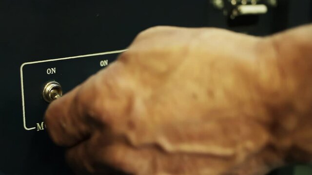 Projectionist Hand Switching Off and On Movie Projector at Cinema. Close-Up. 4K Resolution.