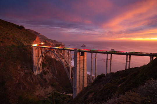 Dramatic sunset at a bridge along the Big Sur coast, California