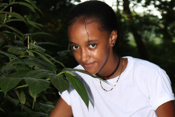 portrait of a teenager in the park in white t-shirt