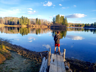 Fototapeta na wymiar boy at lake in the mountains