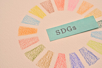 A sketchbook with the symbols of the SDGs and sticky notes stamped with the letters of the SDGs. Images for eye catching and thumbnails.