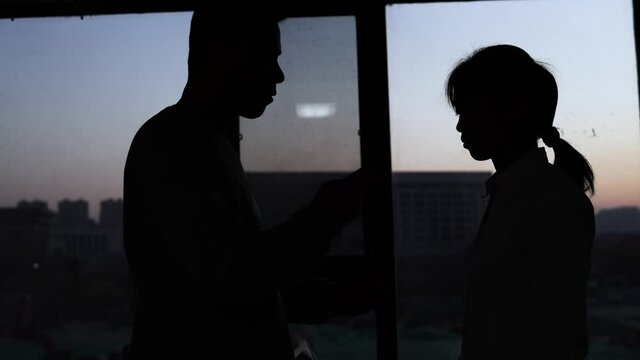A silhouette of bribing subordinates with cash.