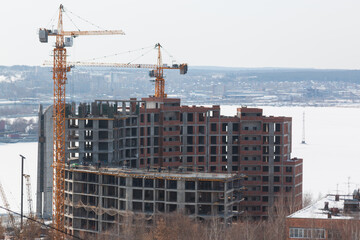 tower crane next to an unfinished house