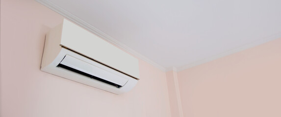 Close up air conditioner split type wall mounted in home room concepts of cool or heat or air...