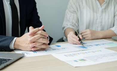 Two business leaders talk about charts, financial graphs showing results are analyzing and calculating planning strategies, business success building processes