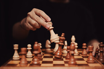 Successful business competition concept. Businessman moving chess piece and checkmate during...