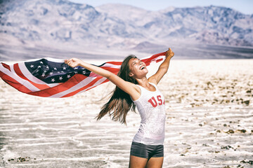 American flag woman USA sport athlete winner cheering waving stars and stripes outdoor after in...