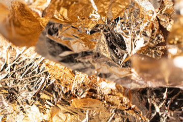 Close-up texture of golden yellow foil foil background texture only focus due to abstract dots