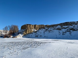 ice covered with snow on the background of snowy hills