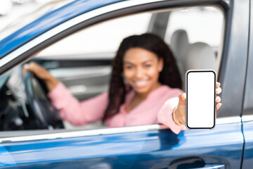 Happy black driver using showing smartphone with empty screen