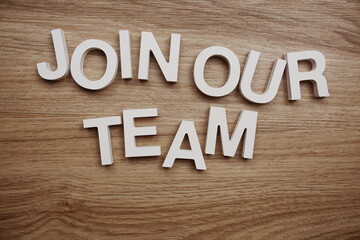 Join Our Team alphabet letters on wooden background