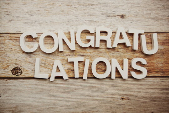 Congratulations alphabet letters on wooden background